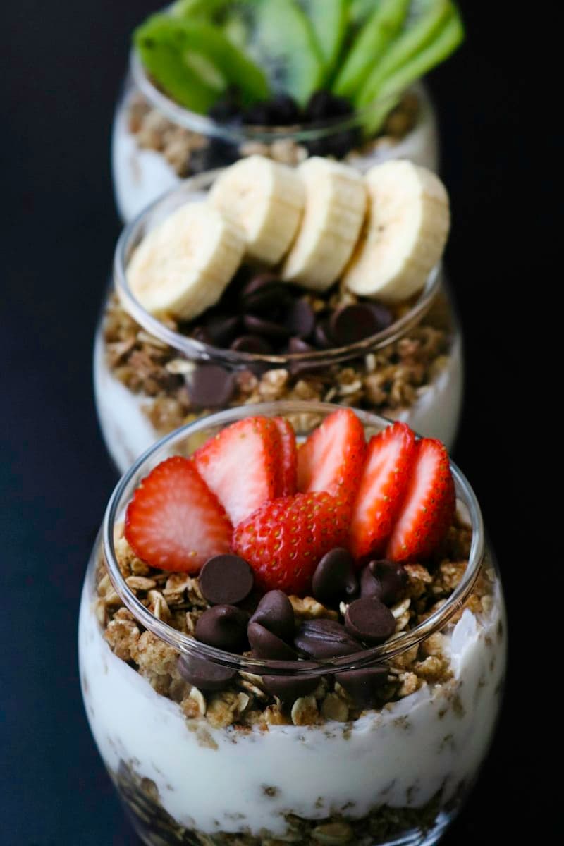 Stacked parfait cups with strawberries, chocolate chips and banana